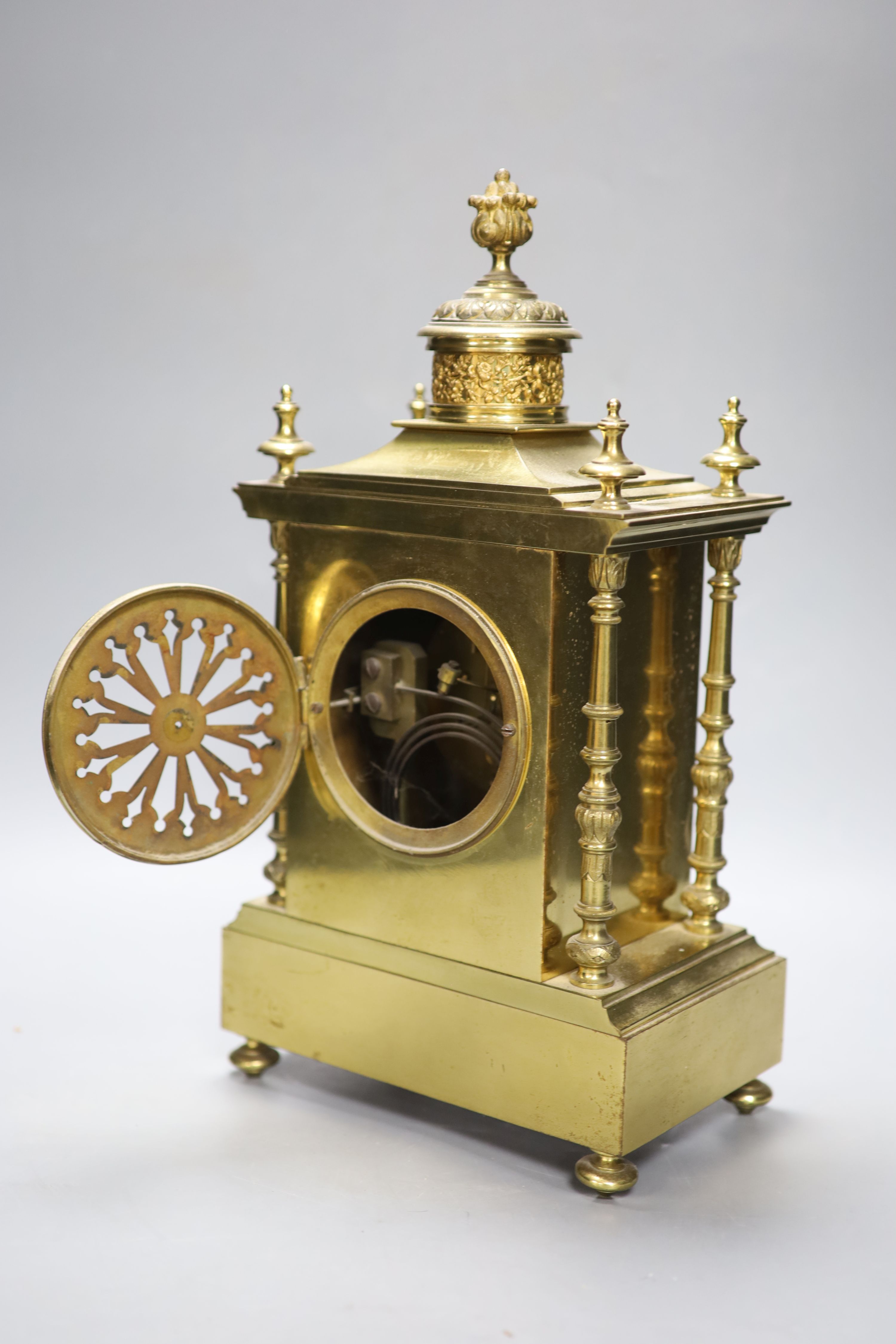 A late 19th century gilt brass three piece clock garniture, the clock with an eight day striking movement, height 39cm